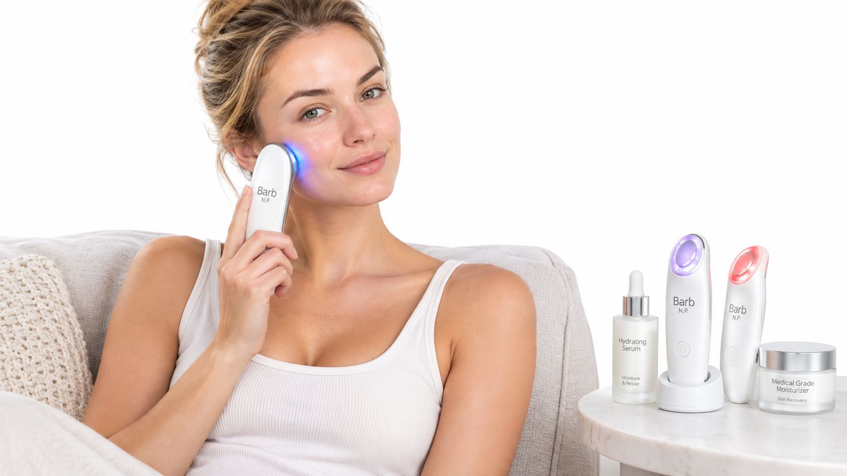 A woman using a light therapy skincare device on her face while sitting next to other beauty products.