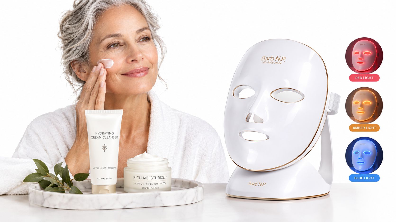 A woman with glowing skin uses a Barb N.P. LED face mask and nourishing facial skincare products.