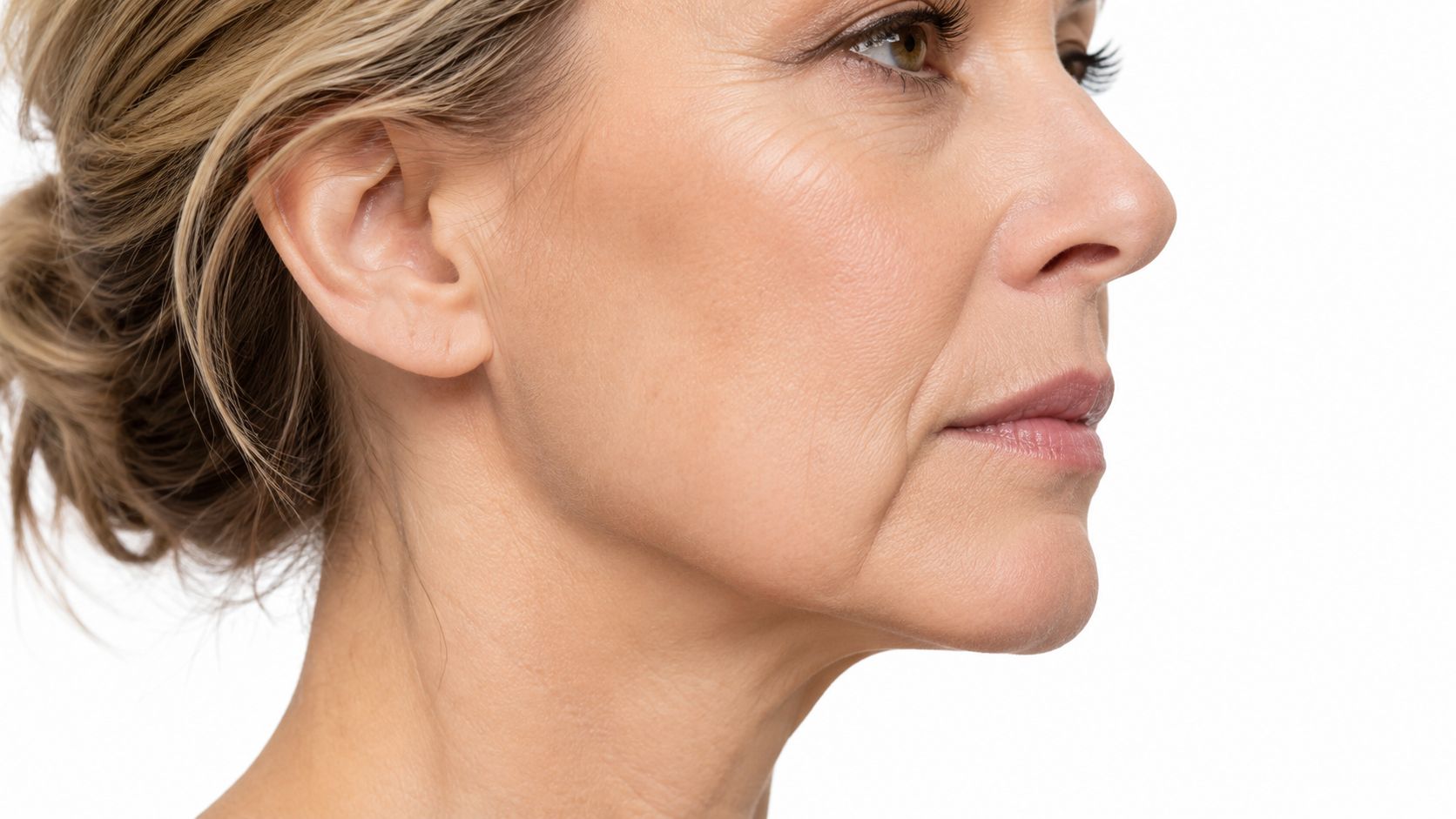 Close up profile view of a mature woman face focusing on skin texture and marionette lines.