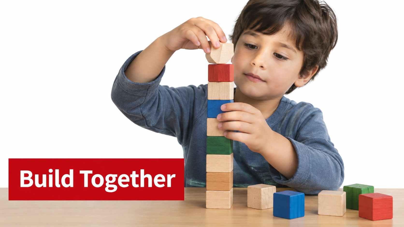 A young boy carefully stacking colorful wooden blocks on a table during play-based learning.