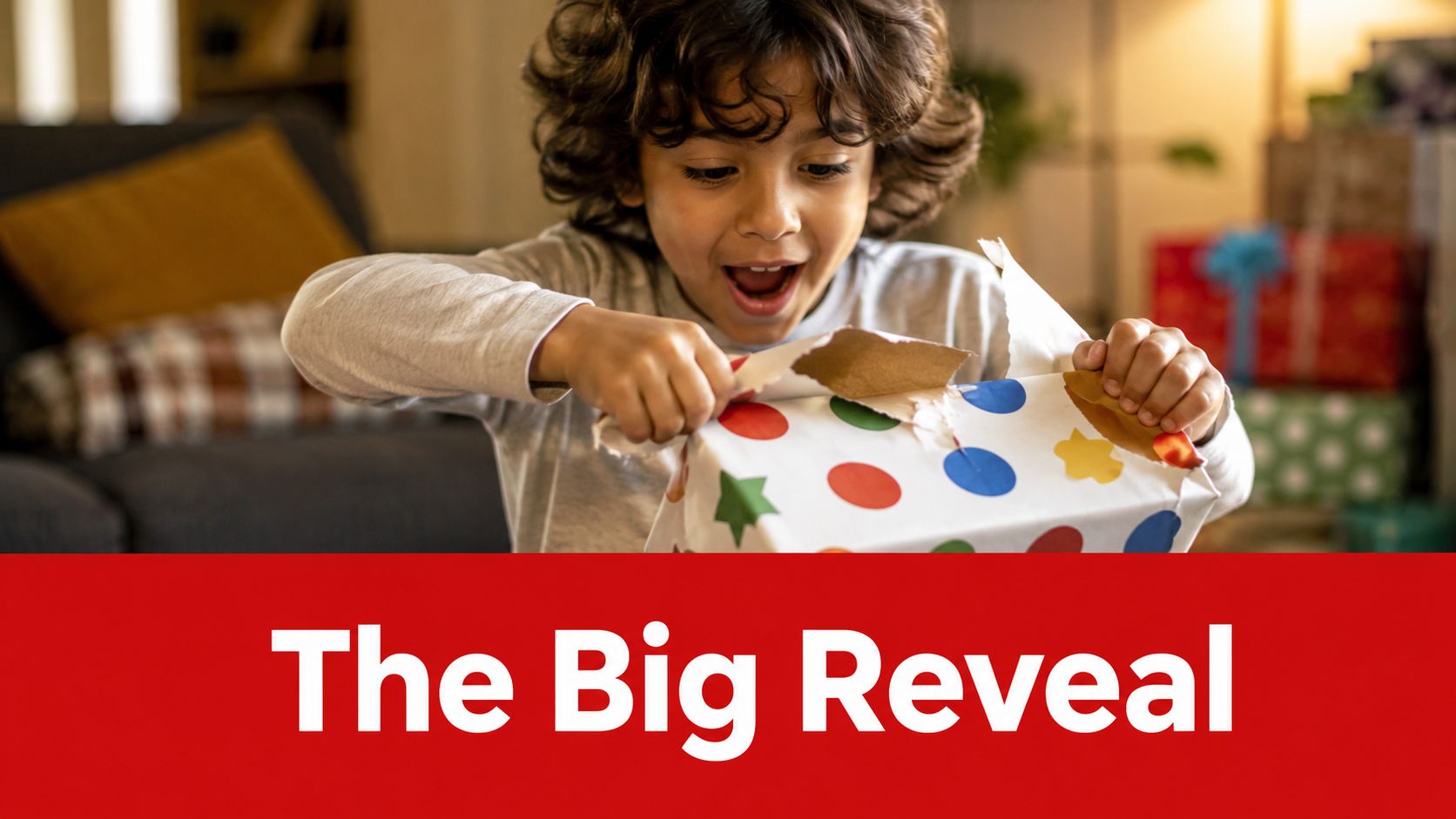 An excited young boy with curly hair joyfully unwrapping a colorful polka-dot gift box at home.