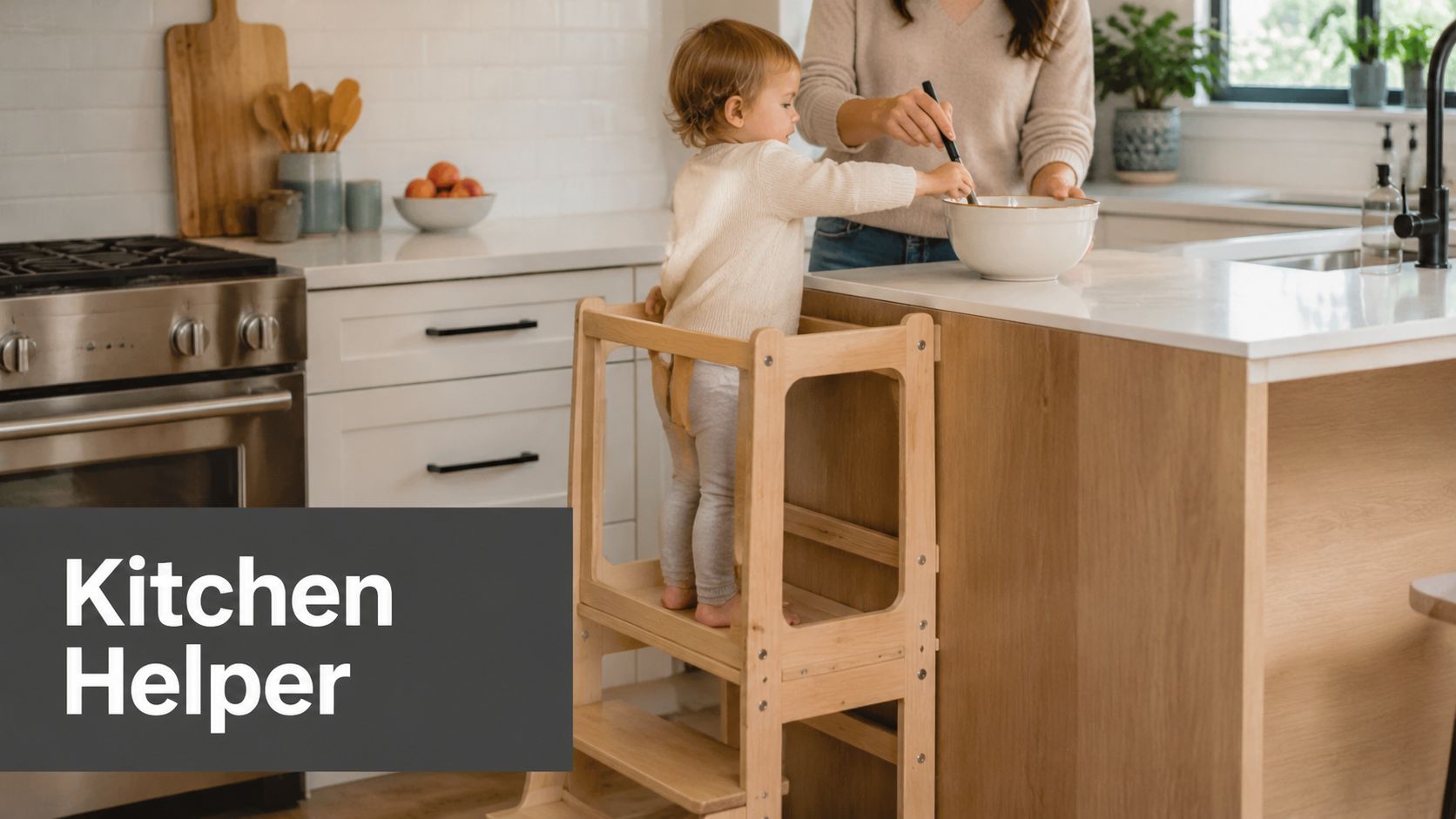 A young child stands on a wooden kitchen helper tower while helping an adult mix in a bowl.