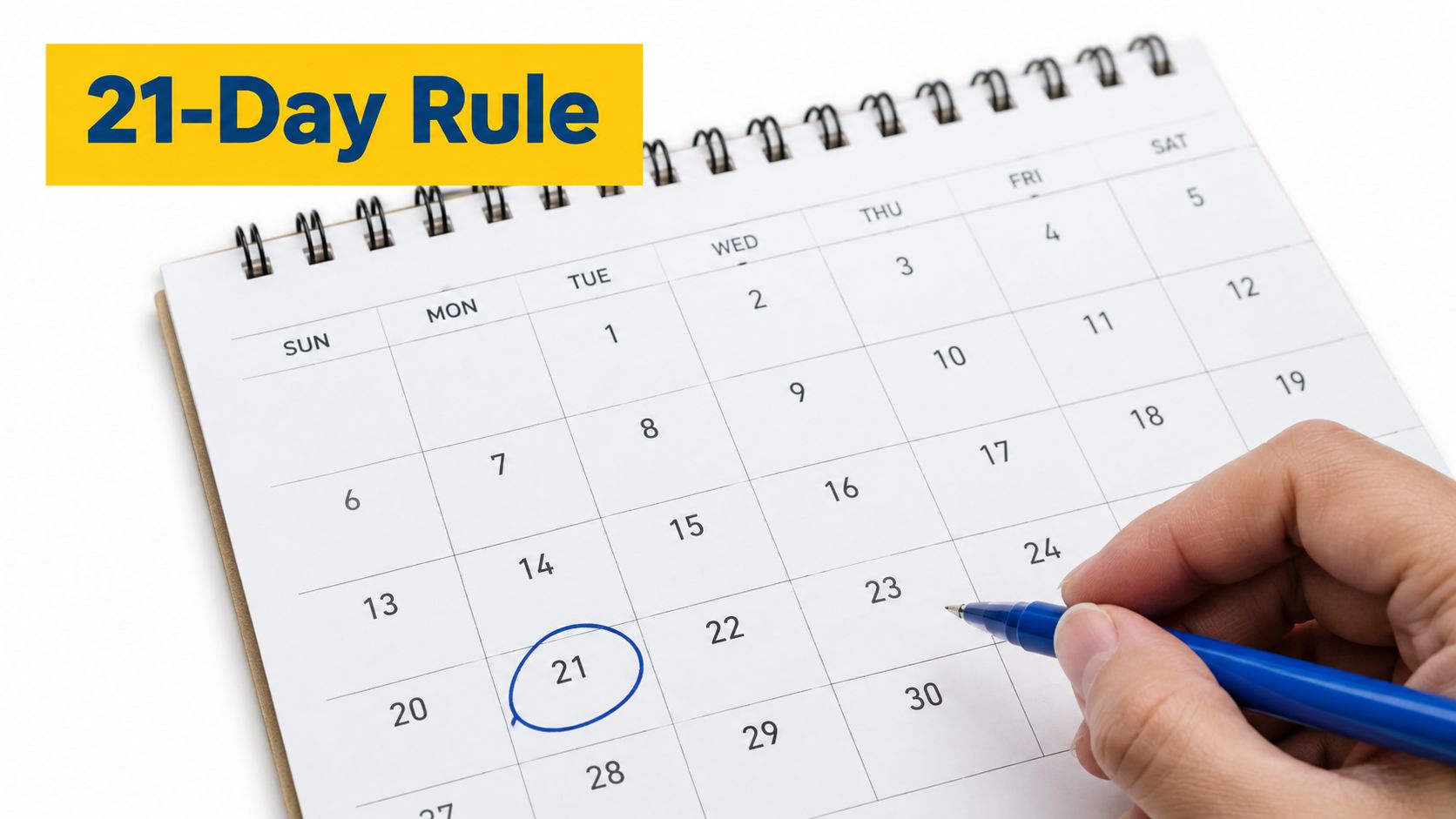A hand holding a blue pen circling the twenty-first day on a white desk calendar.