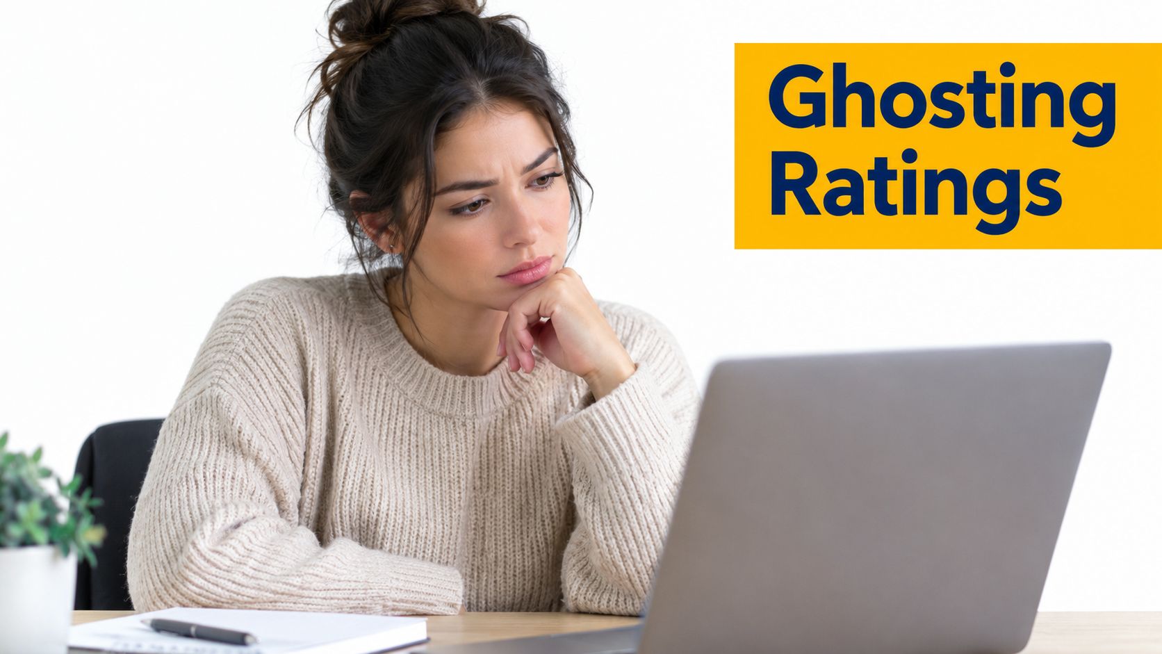 A pensive woman wearing a beige sweater looking at her laptop screen while sitting at a desk.