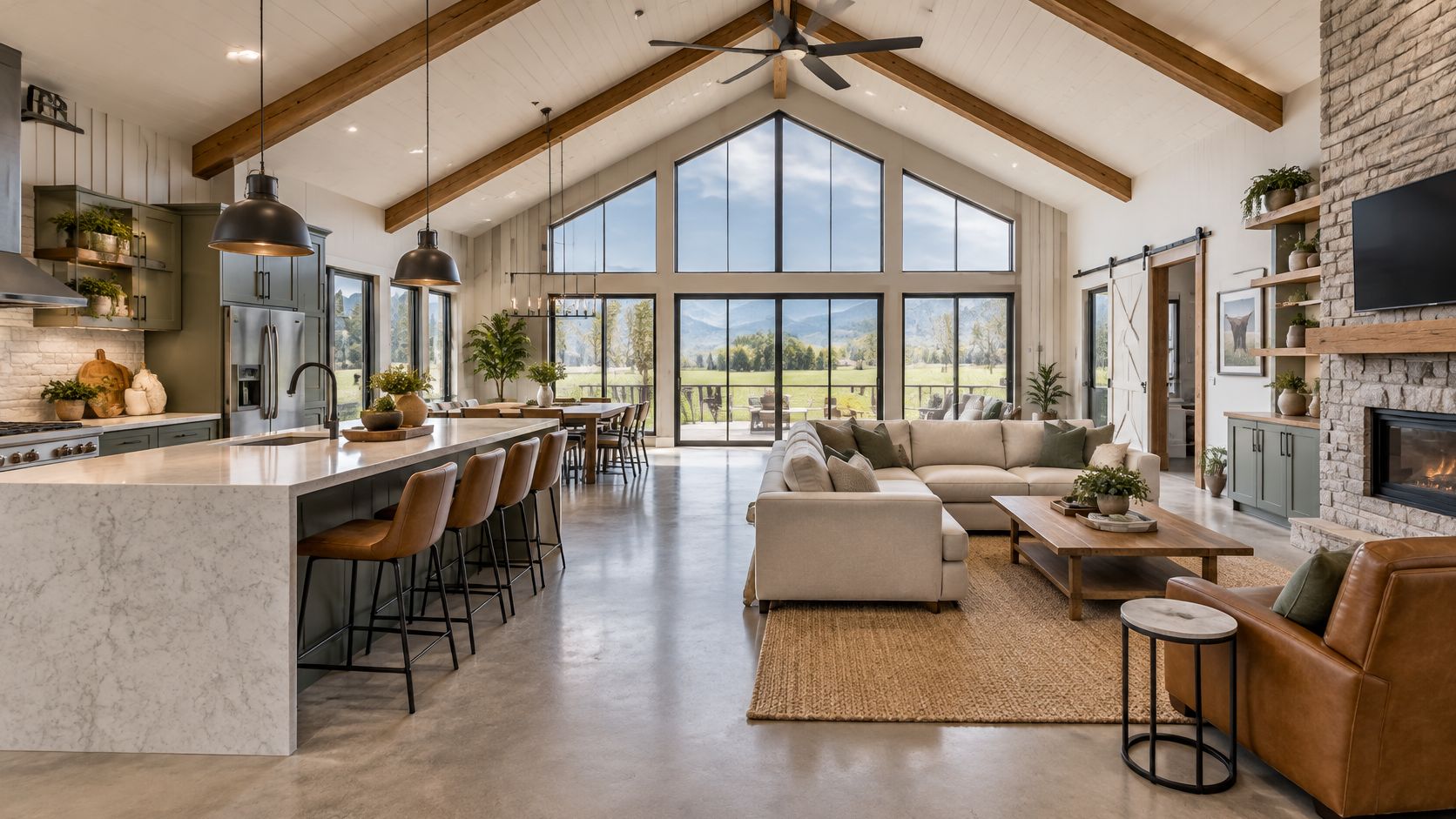 A luxurious open-concept barndominium interior featuring high vaulted ceilings, modern kitchen island, and a cozy living area.