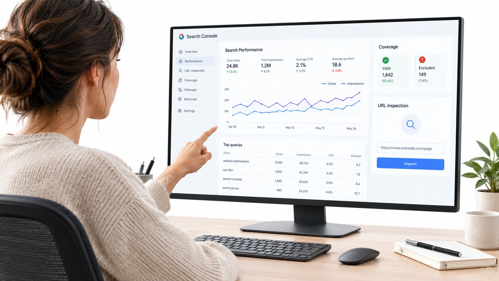 A woman working on a computer screen displaying Google Search Console analytics data for website performance tracking.