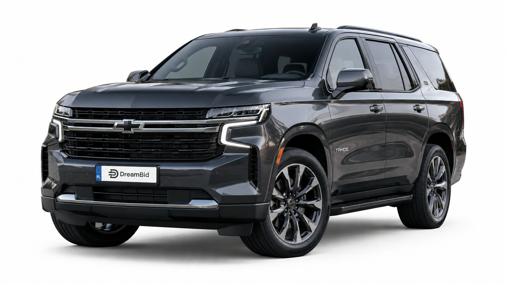 A sleek dark gray Chevrolet Tahoe SUV parked and isolated on a clean white background studio shot.