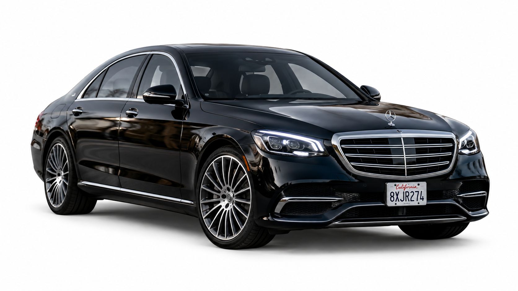 A luxurious black Mercedes-Benz sedan parked against a plain white background, highlighting its sleek modern design.