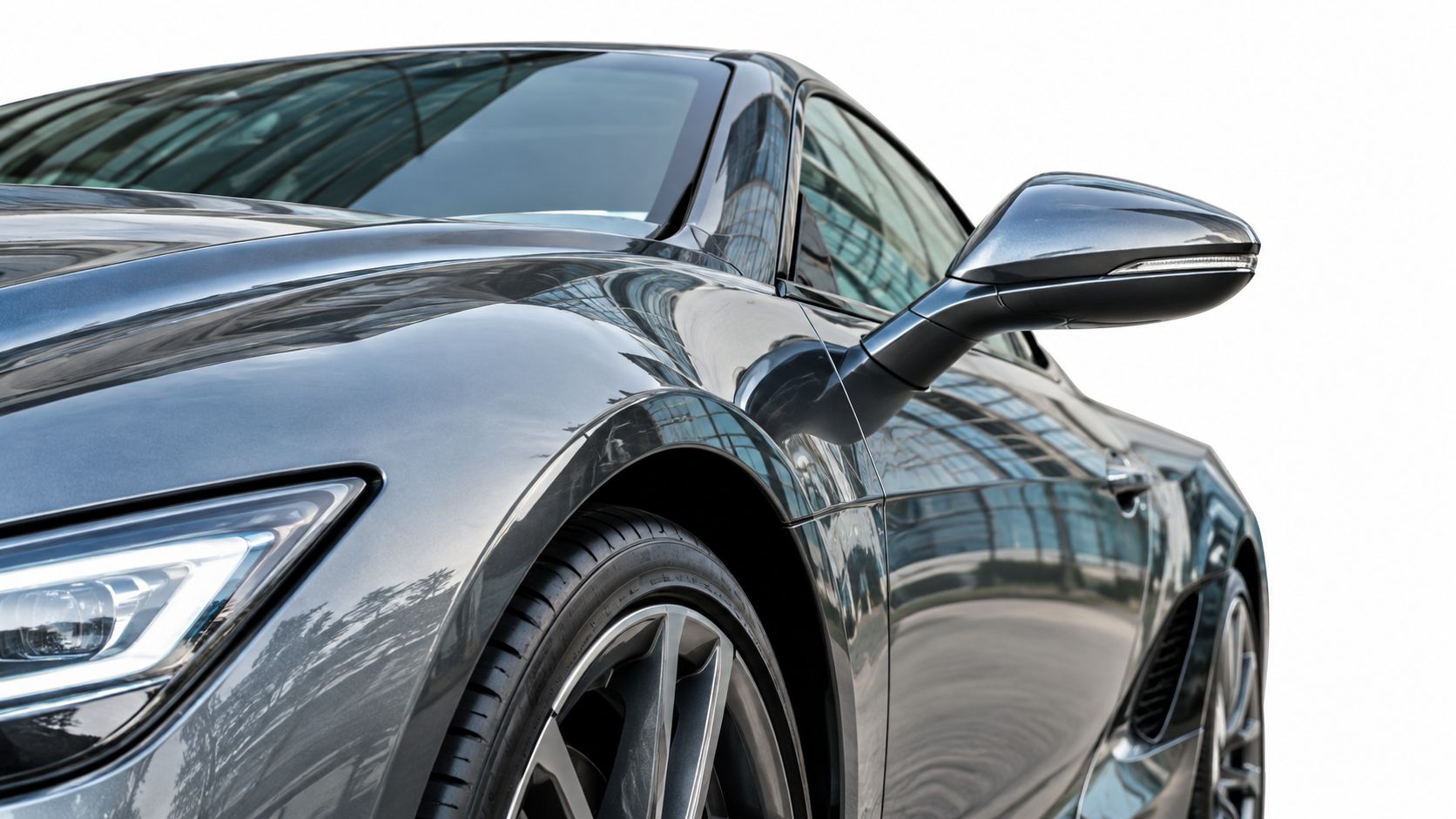 A close-up view of the front section of a sleek grey luxury sports car.