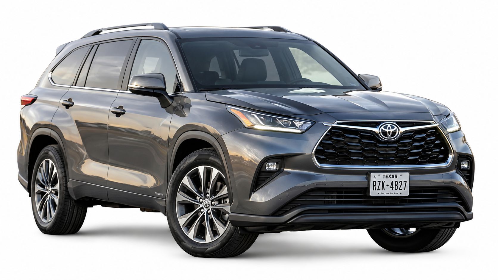 A modern grey Toyota Highlander midsize SUV parked against a plain white background, front three-quarter angle view.
