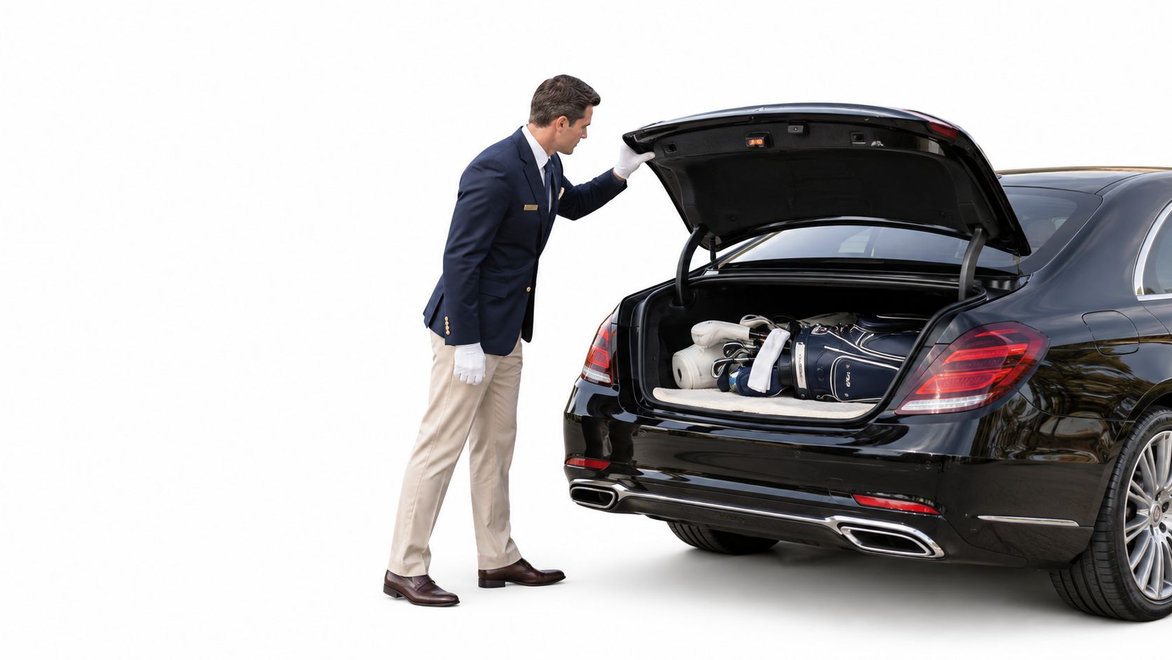 A professional chauffeur wearing white gloves loading a golf bag into the trunk of a black luxury car.