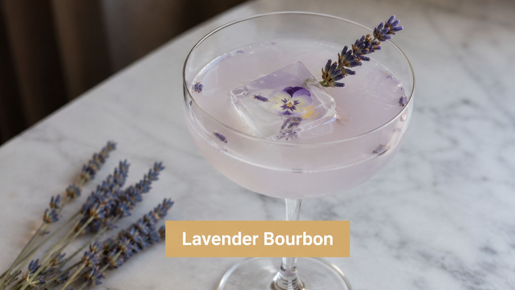 A sophisticated lavender-infused bourbon cocktail in a coupe glass with an edible flower ice cube and garnish.