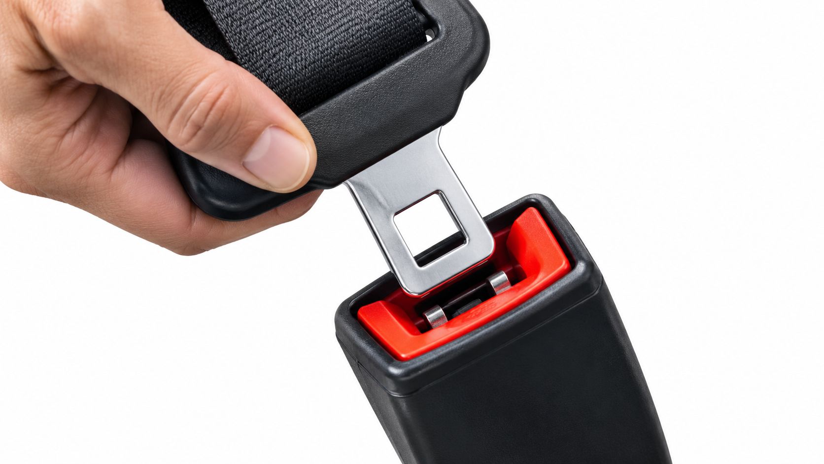 A close-up view of a hand inserting a black car seat belt buckle into the red release button.