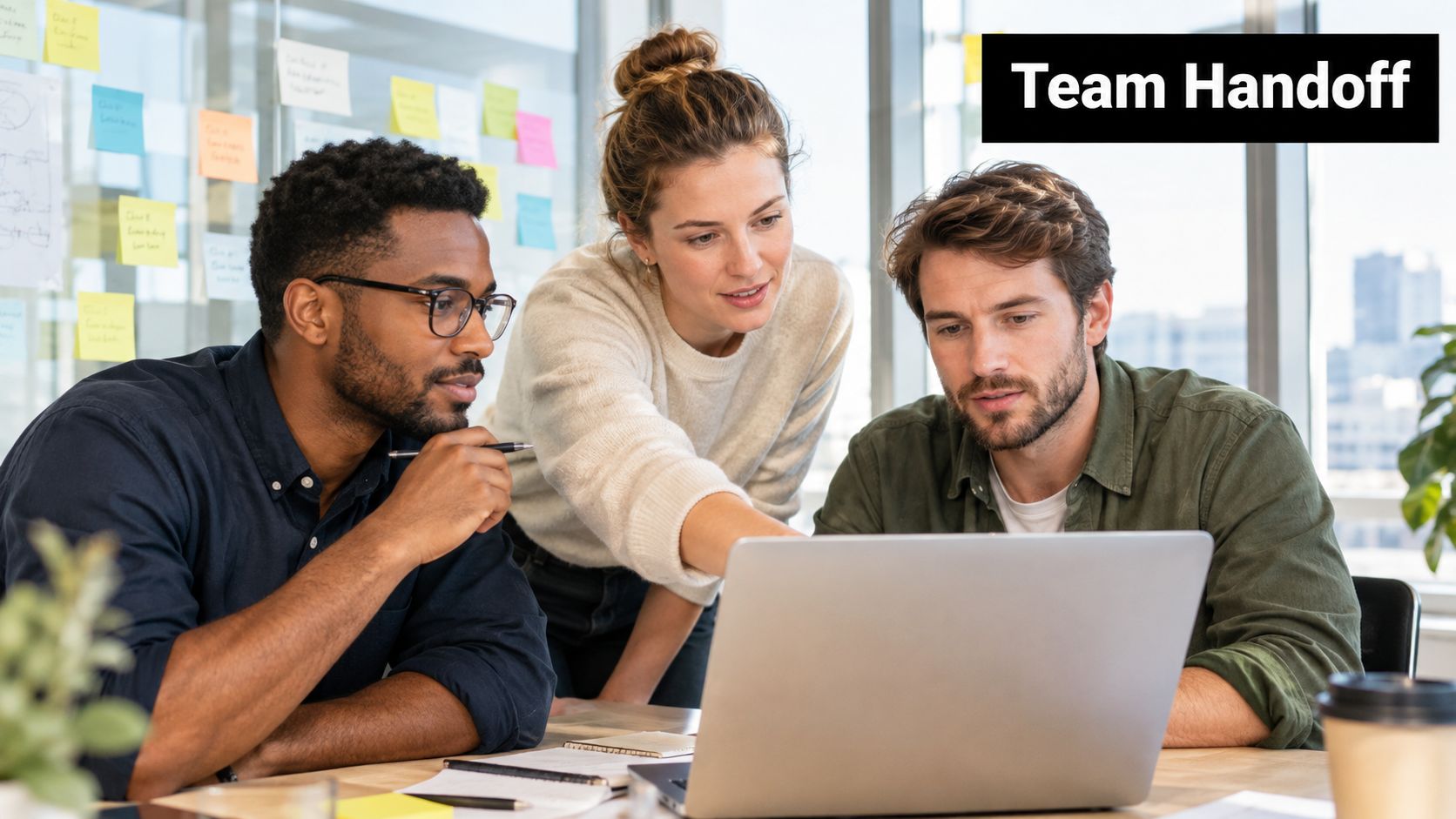 A diverse team of three professional colleagues collaborating together on a laptop project in a modern office.