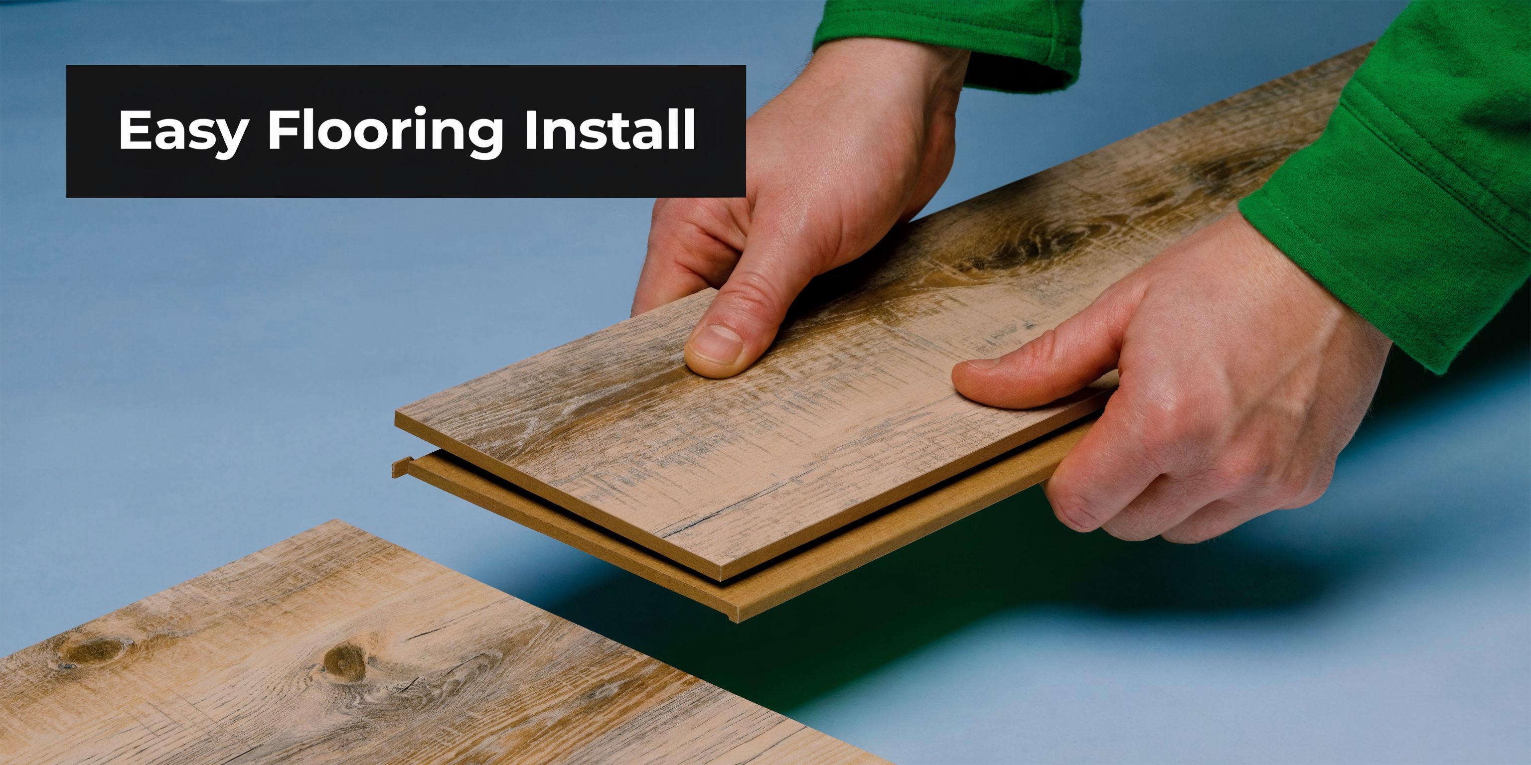 A close-up view of hands installing a wood-look vinyl plank floor using a click-lock system.