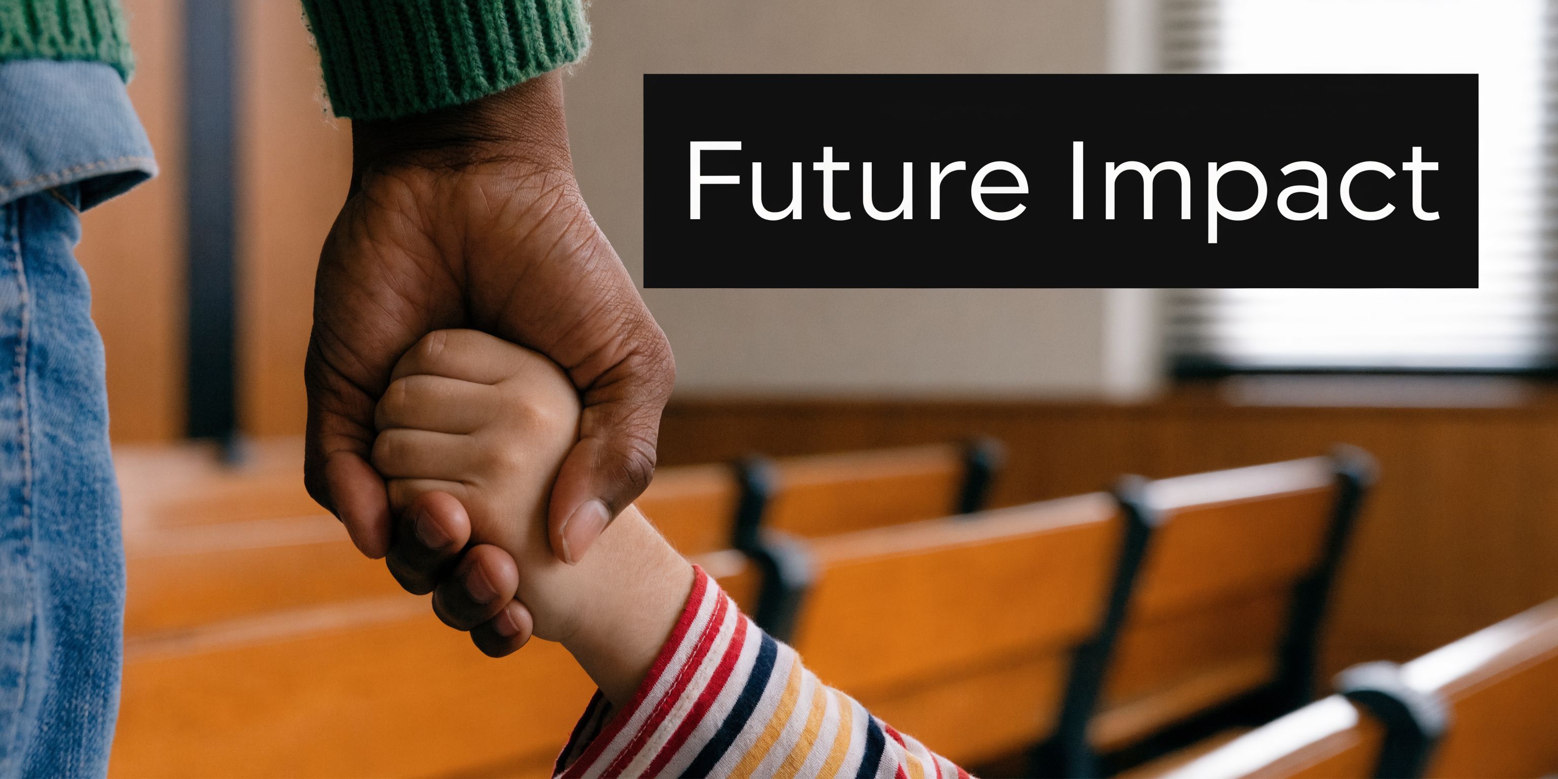 An adult holding a child's hand inside a courtroom setting, symbolizing care and future stability.