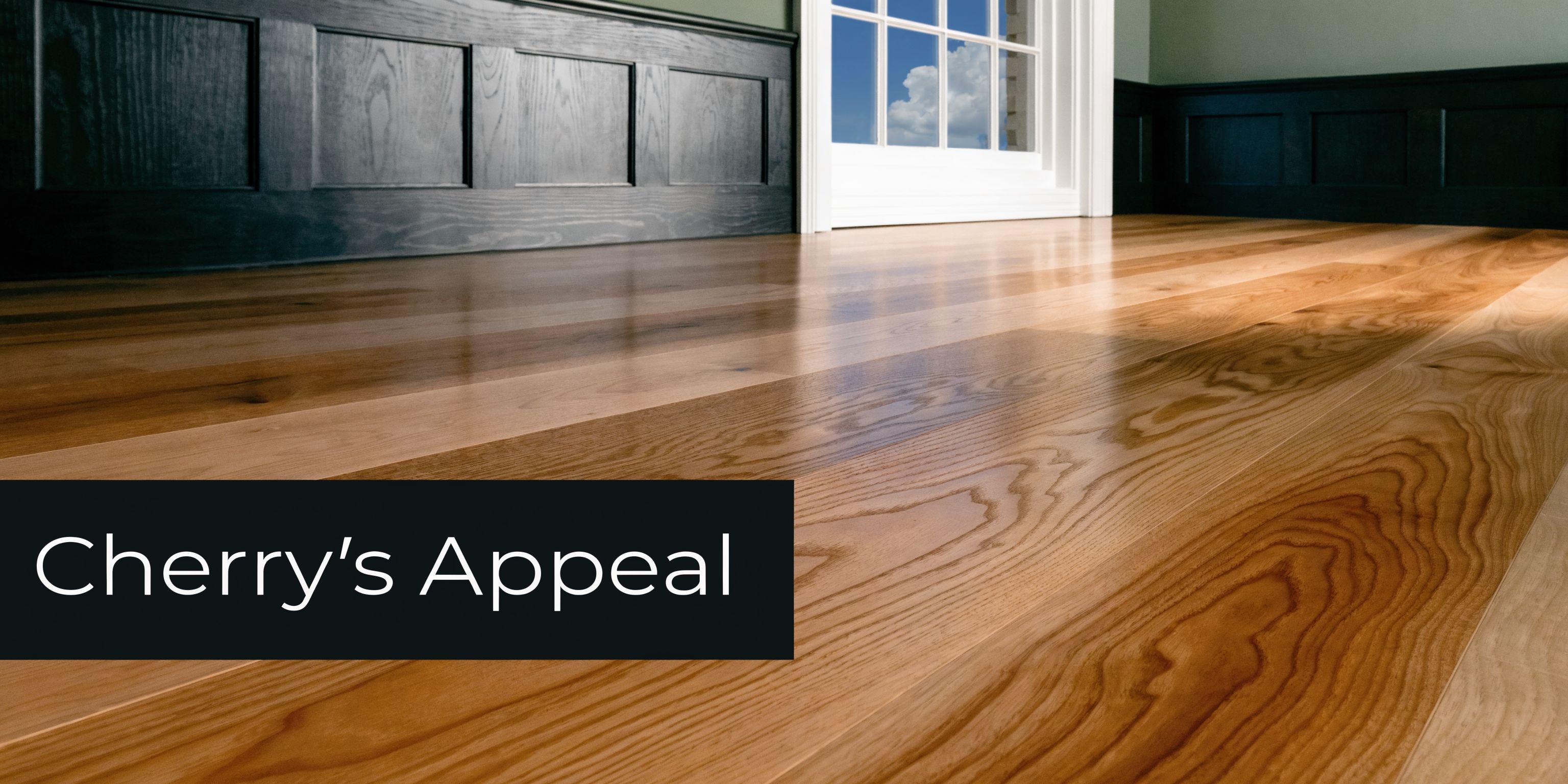 A close-up view of polished natural cherry wood flooring with elegant wainscoting and a bright window.