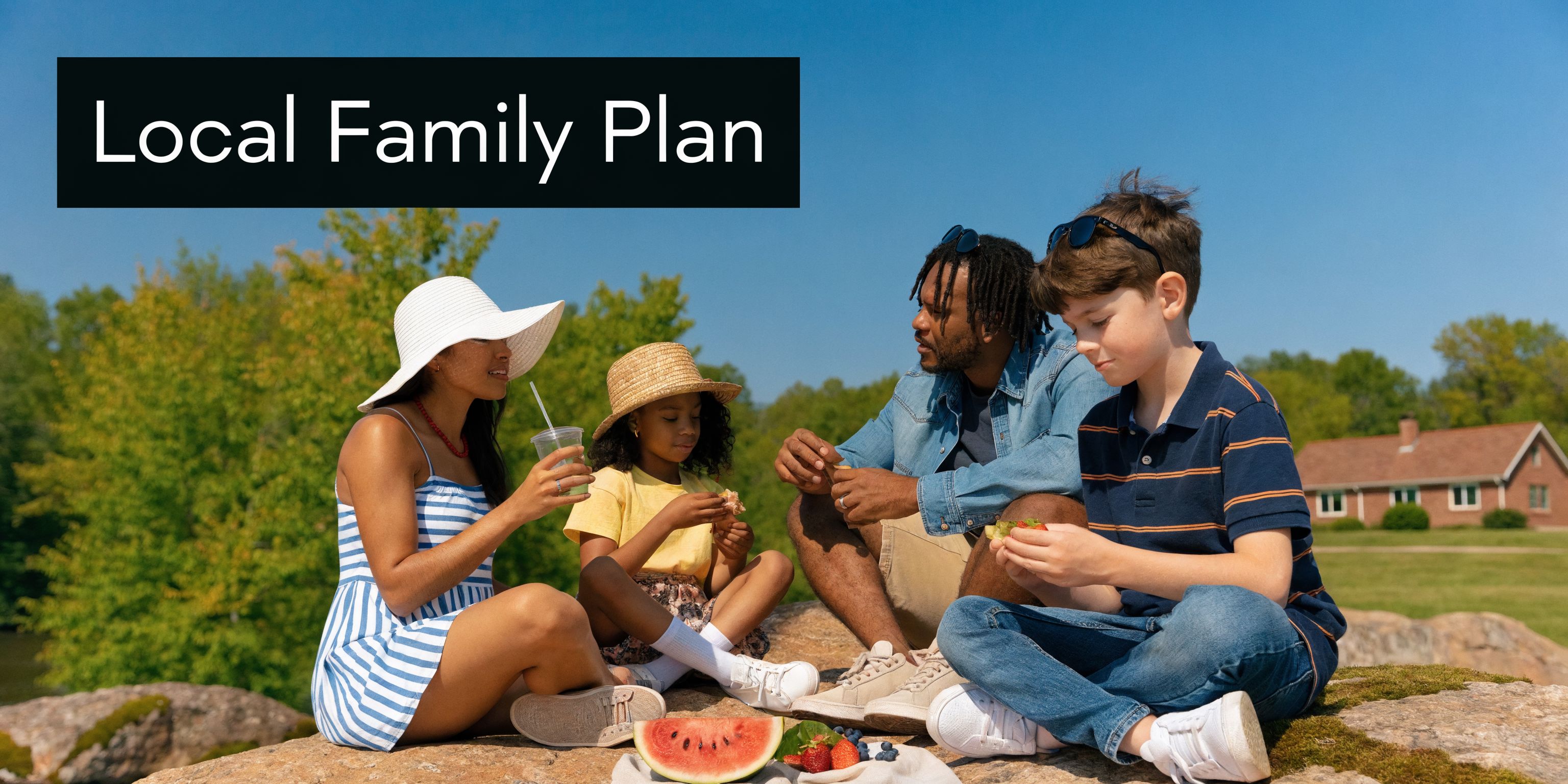 A happy multicultural family enjoying a picnic together on a sunny day in an outdoor park.
