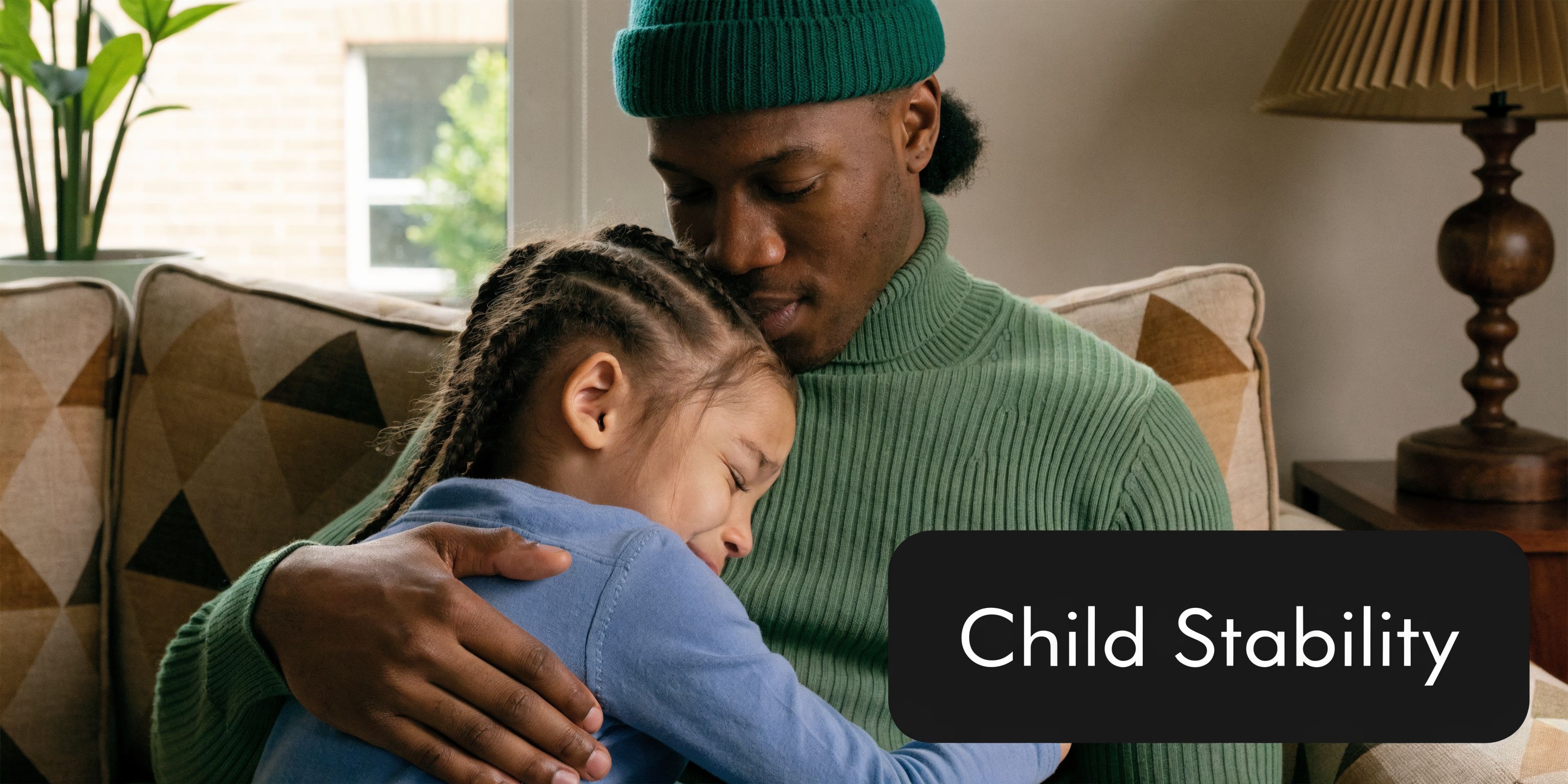 A close-up of a parent lovingly hugging a child, illustrating the importance of a stable environment.