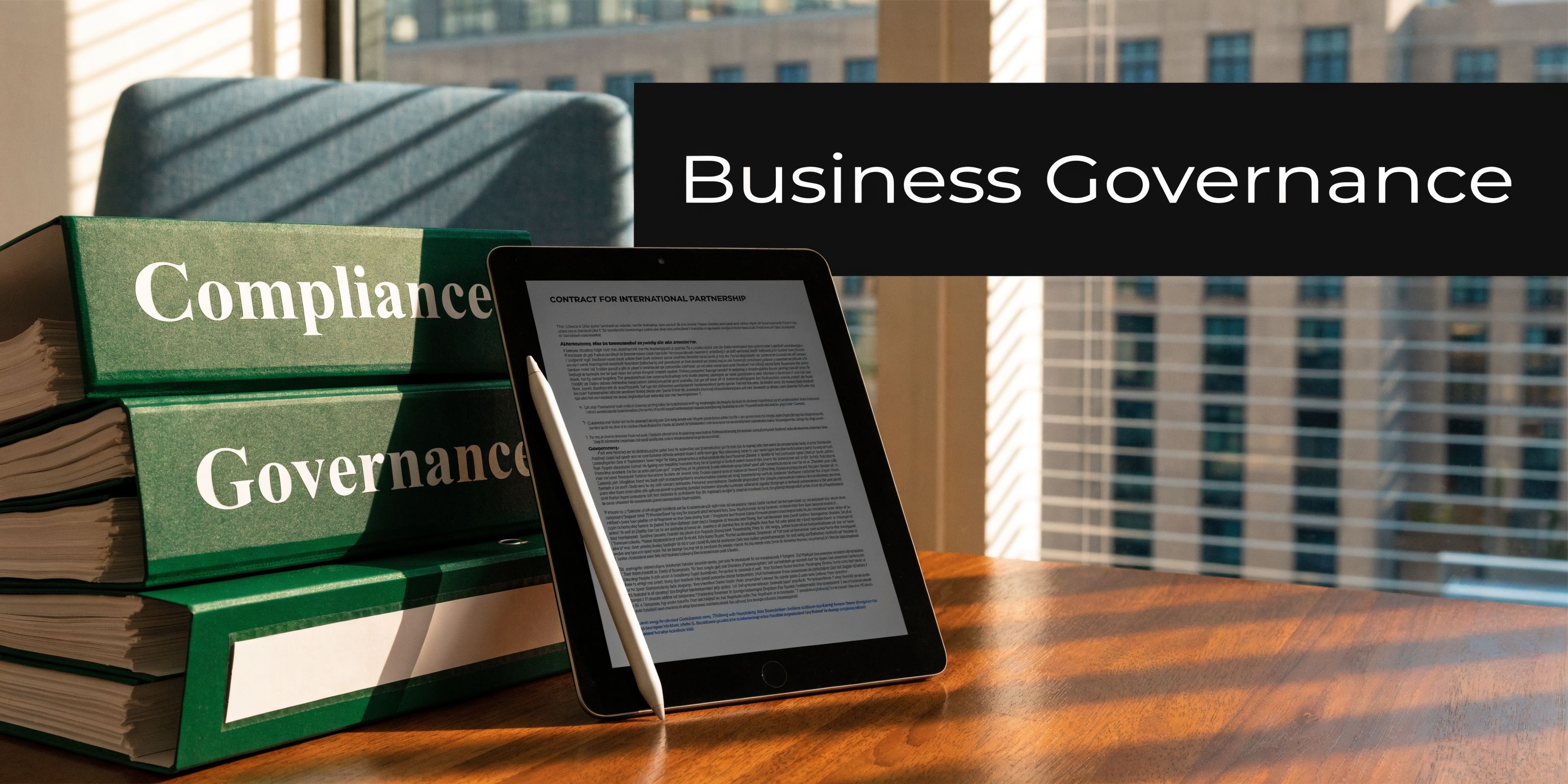 A tablet displaying an international partnership contract next to a stack of books labeled compliance and governance.