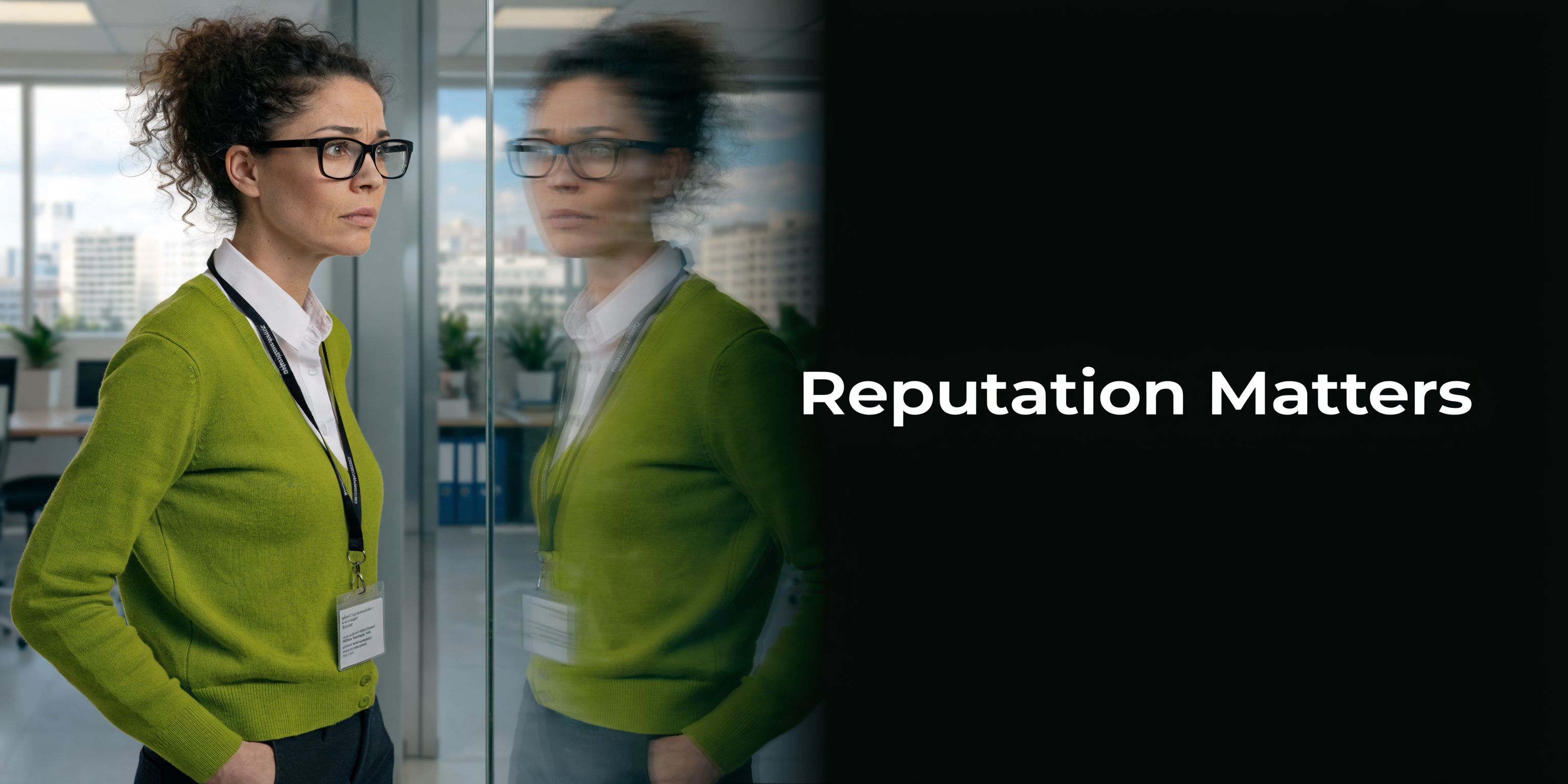 A professional woman in a green sweater looking thoughtfully through a glass office partition.