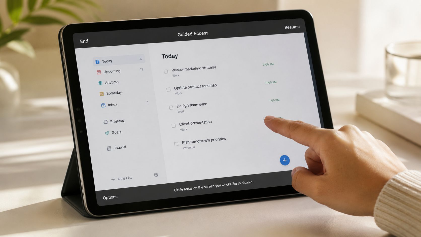 A person using an Apple iPad to configure guided access settings to block specific app screen areas.