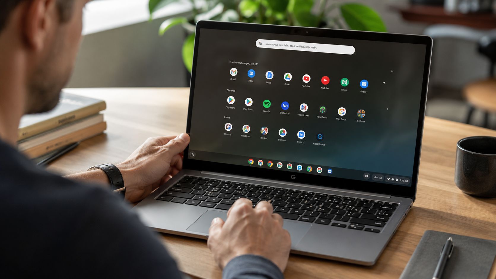 A person using a laptop to manage applications on their ChromeOS desktop environment.
