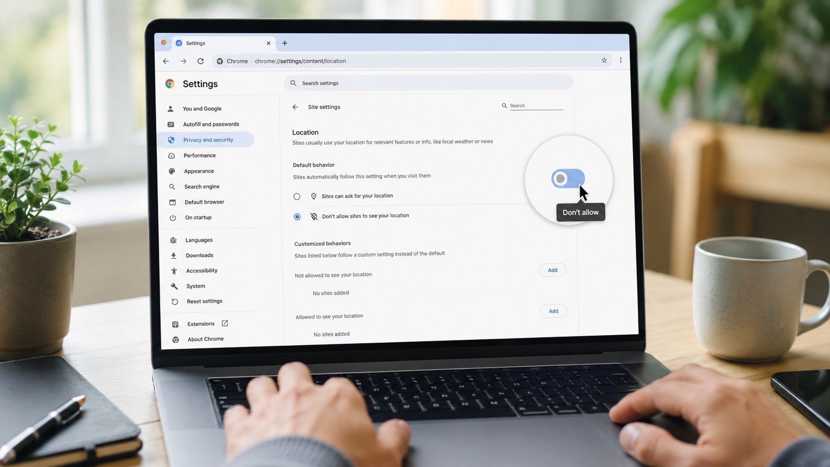 A person using a laptop to navigate the Google Chrome browser settings for location privacy controls.