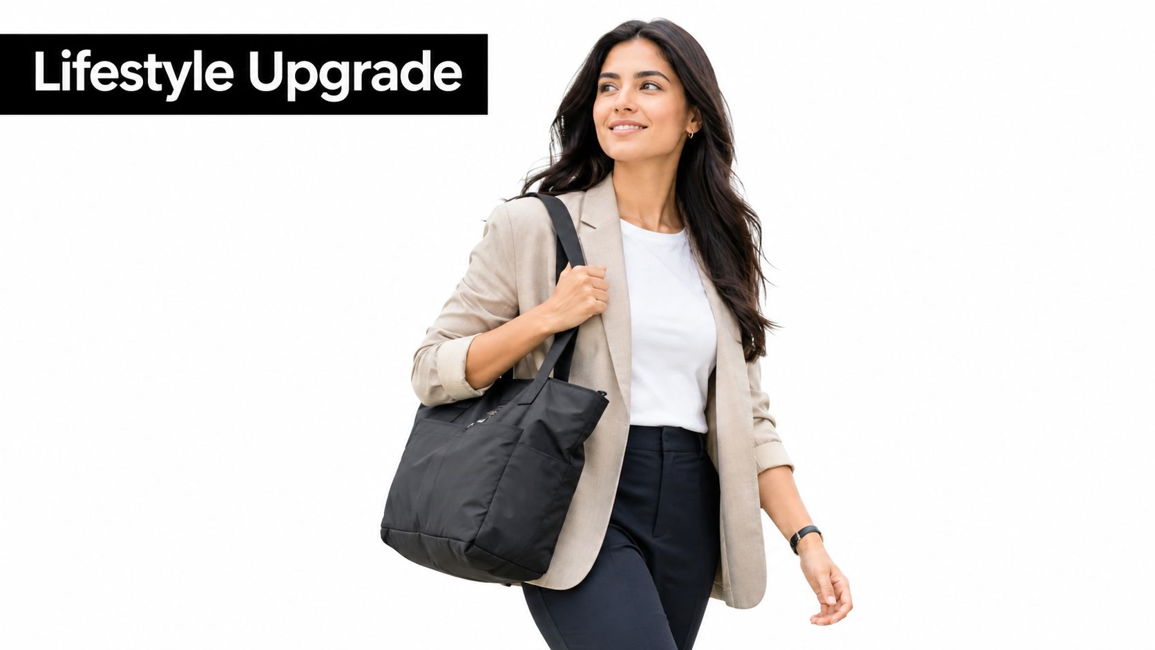 A professional woman wearing a beige blazer walking and carrying a black foldable travel tote bag.