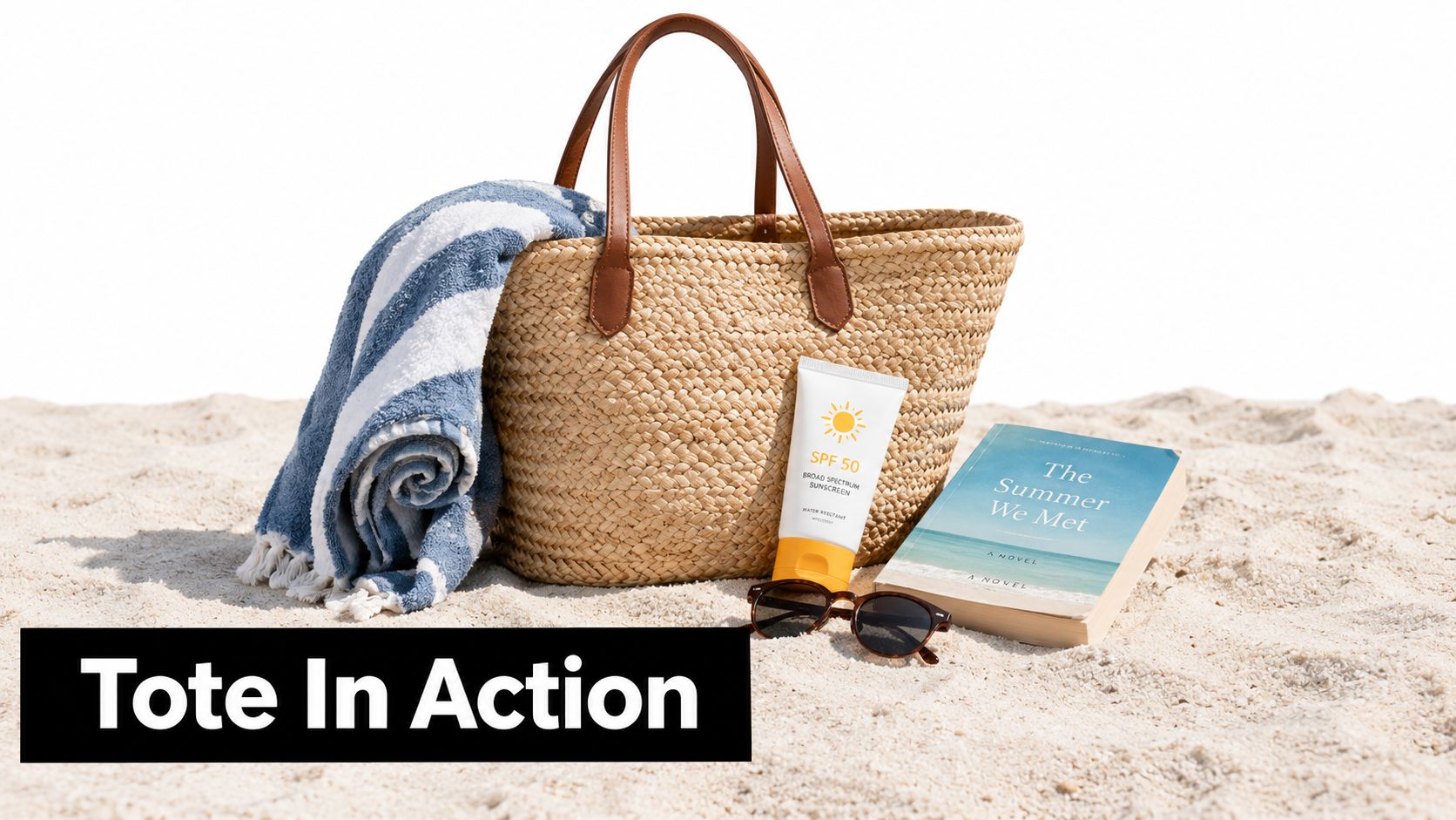 A straw beach tote bag filled with a striped towel, sunscreen, and a book on sand.
