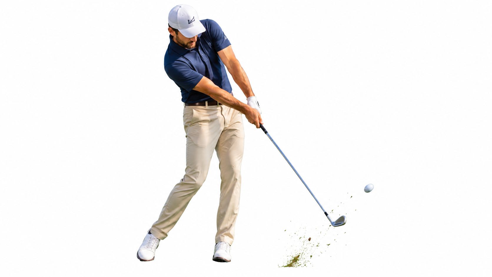 A professional male golfer swinging a seven iron golf club, hitting a golf ball into the air.