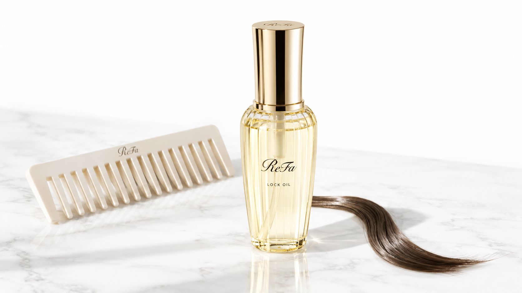 A glass bottle of ReFa hair oil with a matching comb and hair strand on marble surface.
