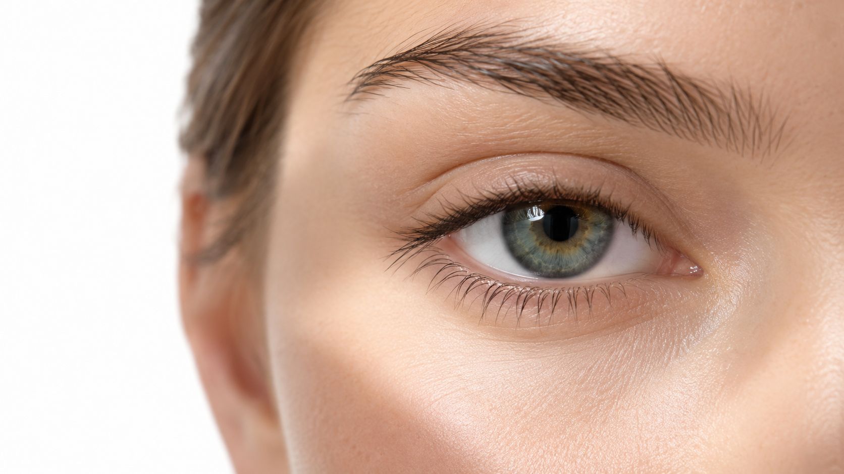 Close up view of a person with natural lashes and a detailed view of the human eye.