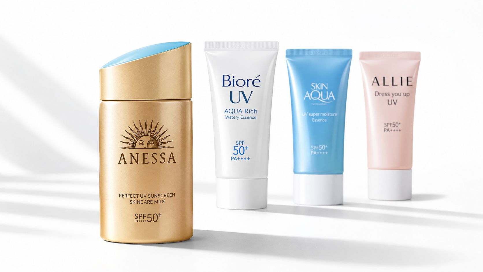 Four different bottles and tubes of popular Japanese sunscreen brands displayed on a white studio background.