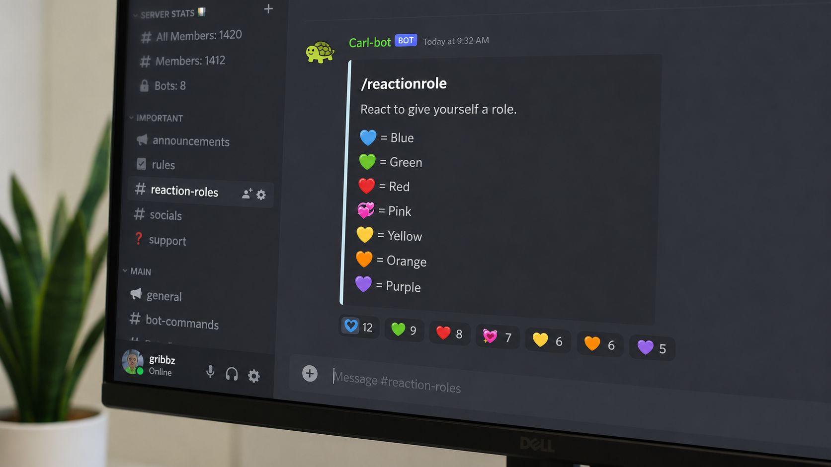 A close-up view of a computer monitor displaying a Discord channel with Carl-bot reaction role settings.