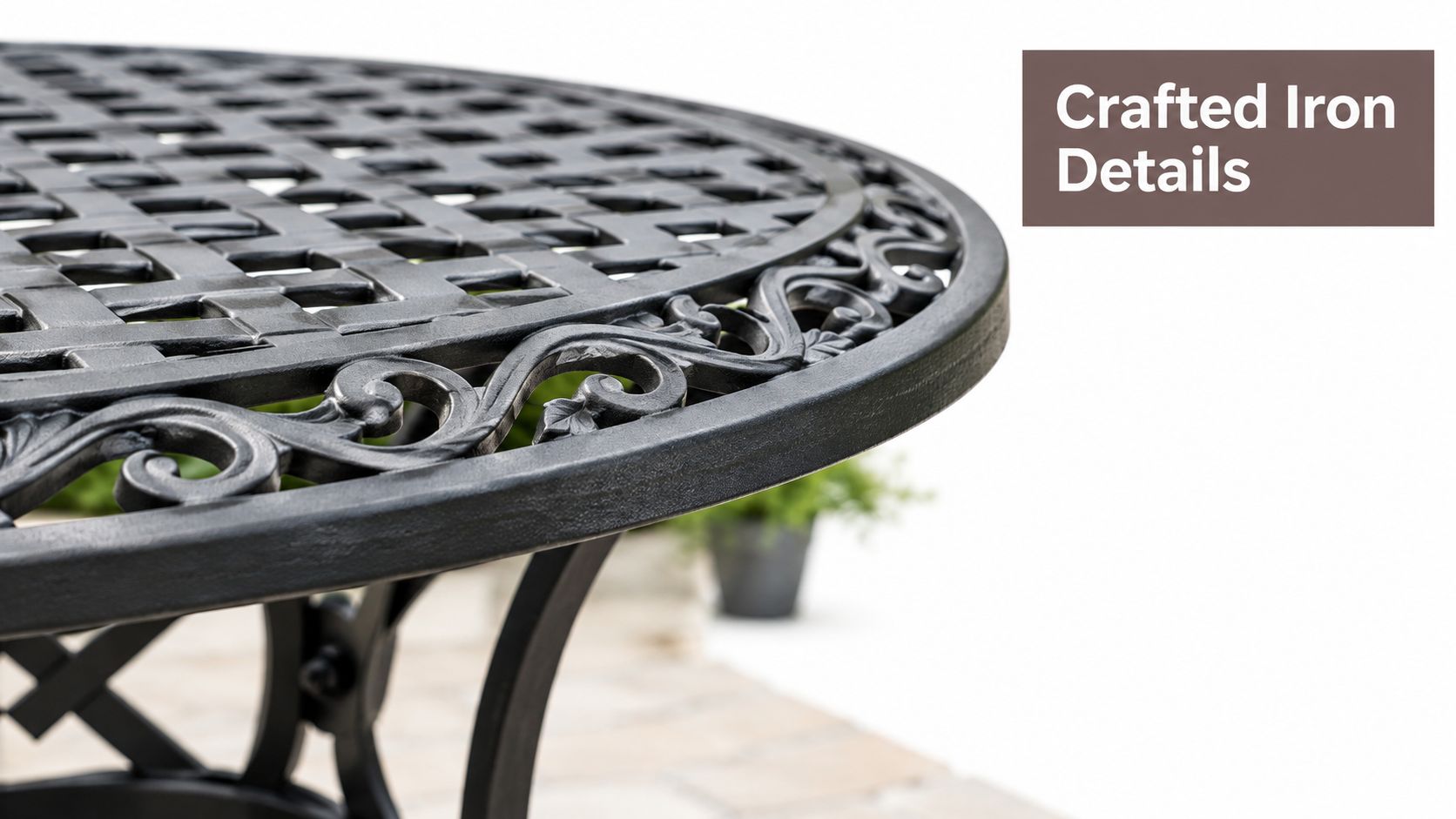 A close-up view of a black ornate iron outdoor table featuring a decorative scrollwork edge.
