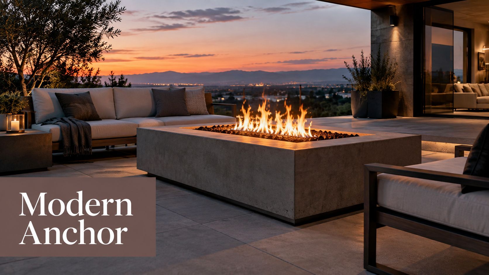 A modern concrete outdoor fire pit on a luxurious patio overlooking a sunset mountain view at twilight.