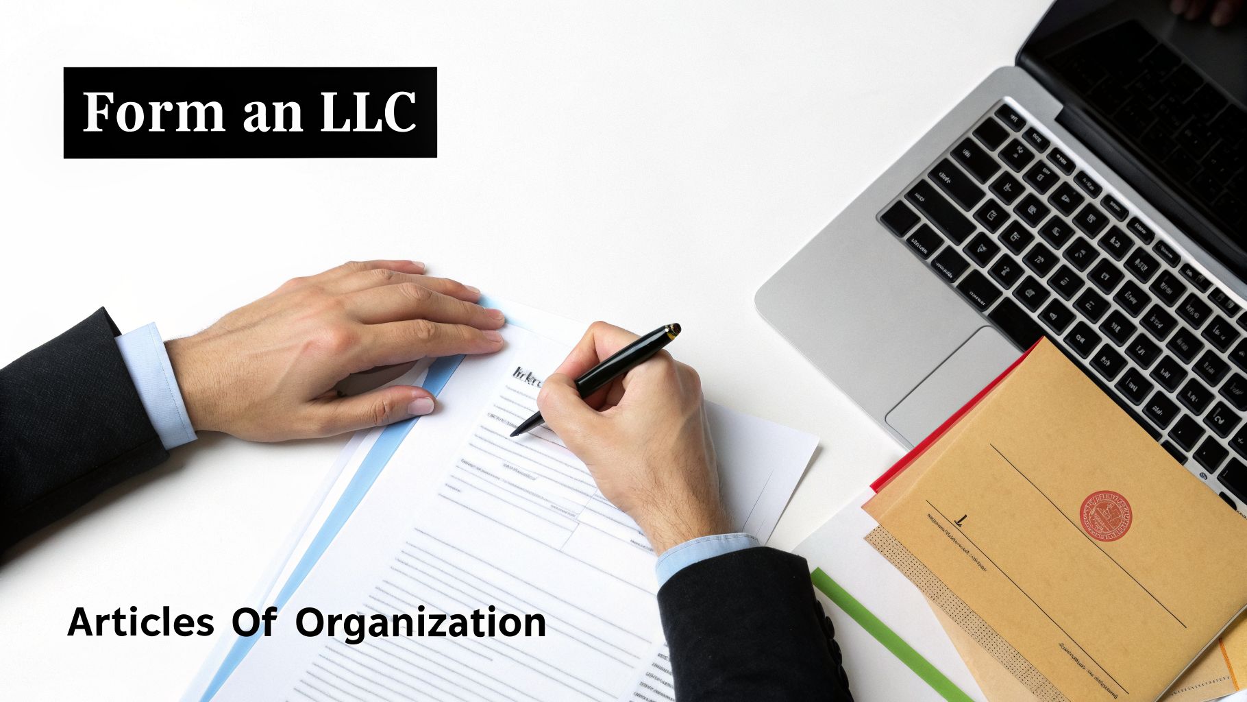 A person's hands signing 'Articles Of Organization' for an LLC on a desk with a laptop.