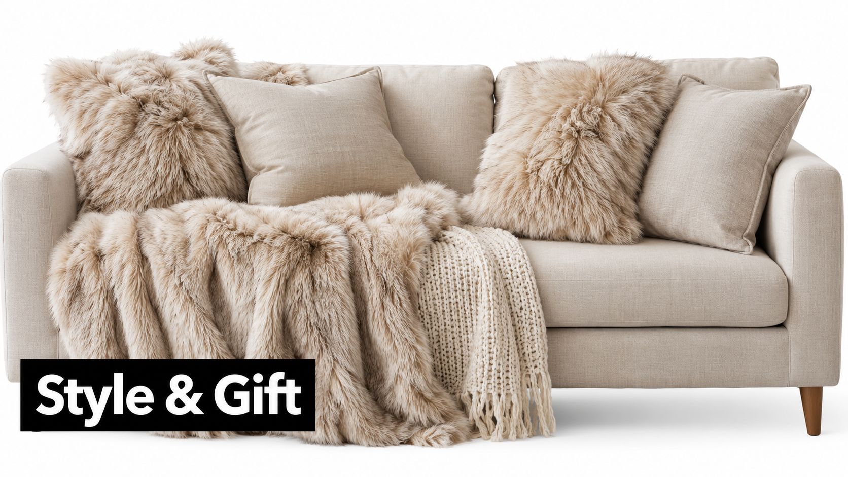 A cozy light beige sofa decorated with soft faux fur pillows and a matching plush throw blanket.