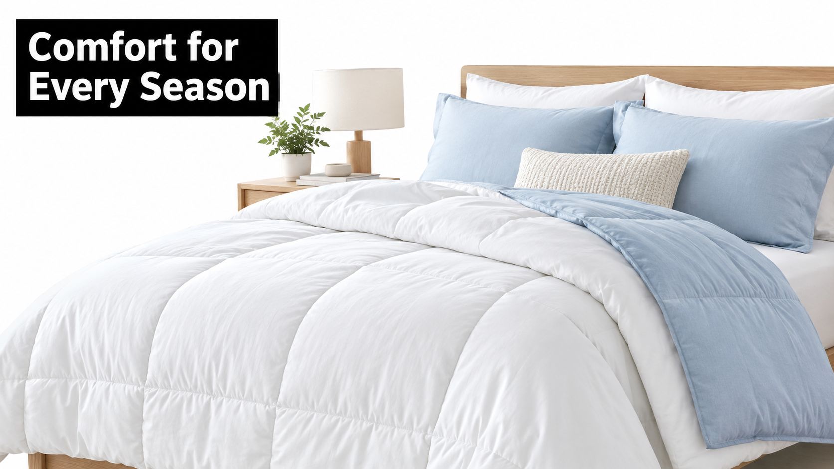A cozy, neatly made bed featuring a white down comforter with a light blue accent blanket.