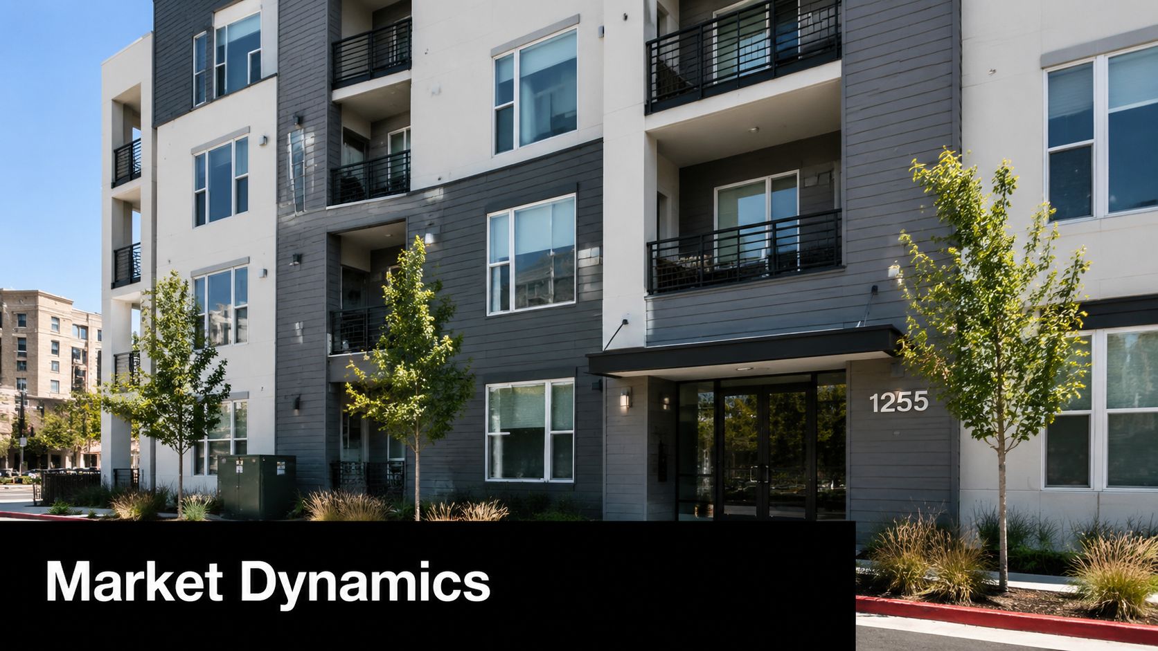 Exterior view of a modern apartment building with a street address of 1255 under a clear sky.