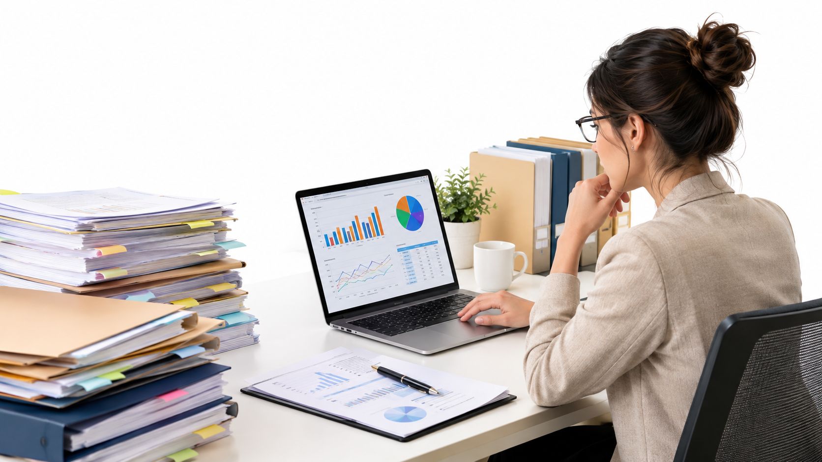 A professional woman analyzing business data and financial charts on her laptop at a cluttered desk.