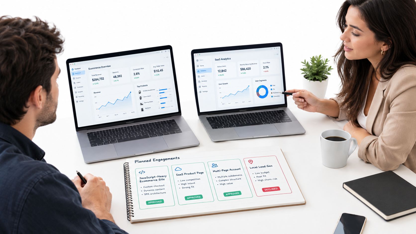 A professional man and woman discussing digital marketing analytics on laptops and reviewing a project planning notebook.