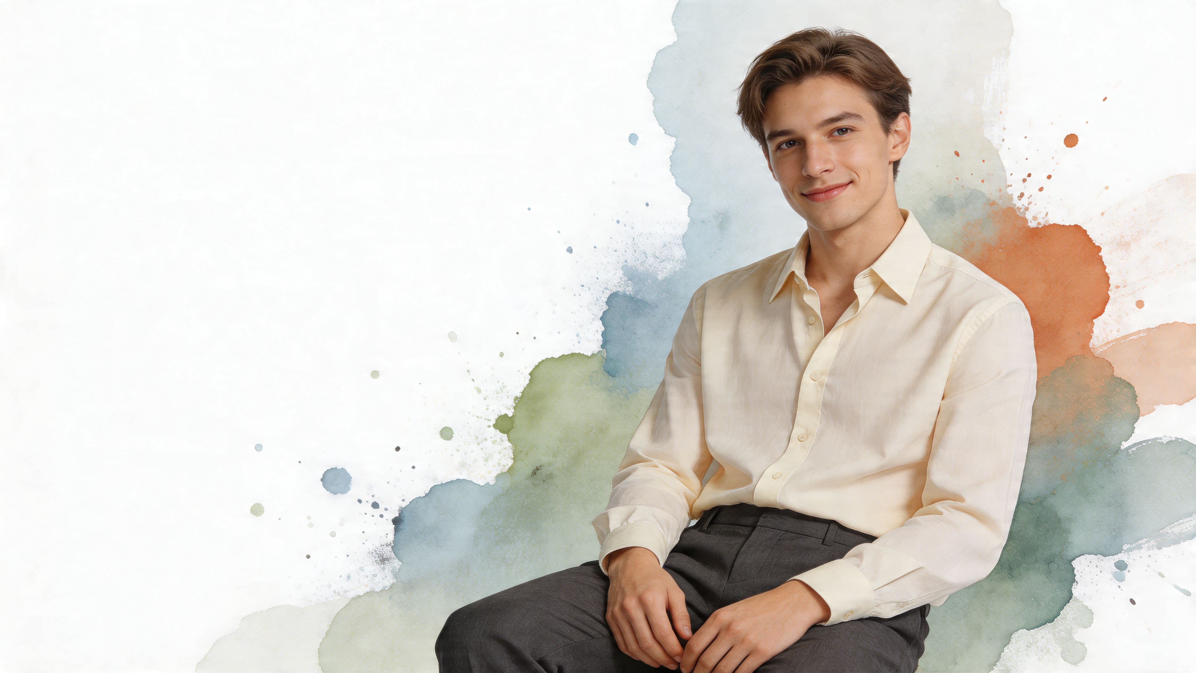 A young man with light brown hair wearing a cream colored button-down shirt posing against watercolor background.