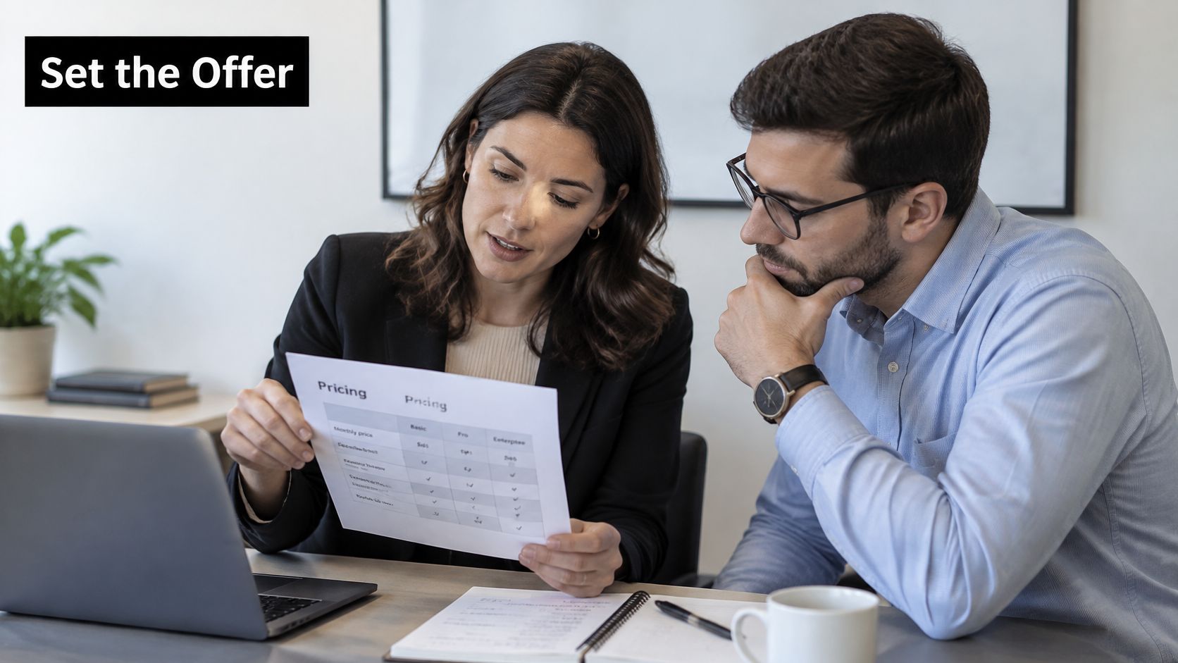 A professional woman and man reviewing a pricing chart document while sitting at an office desk.