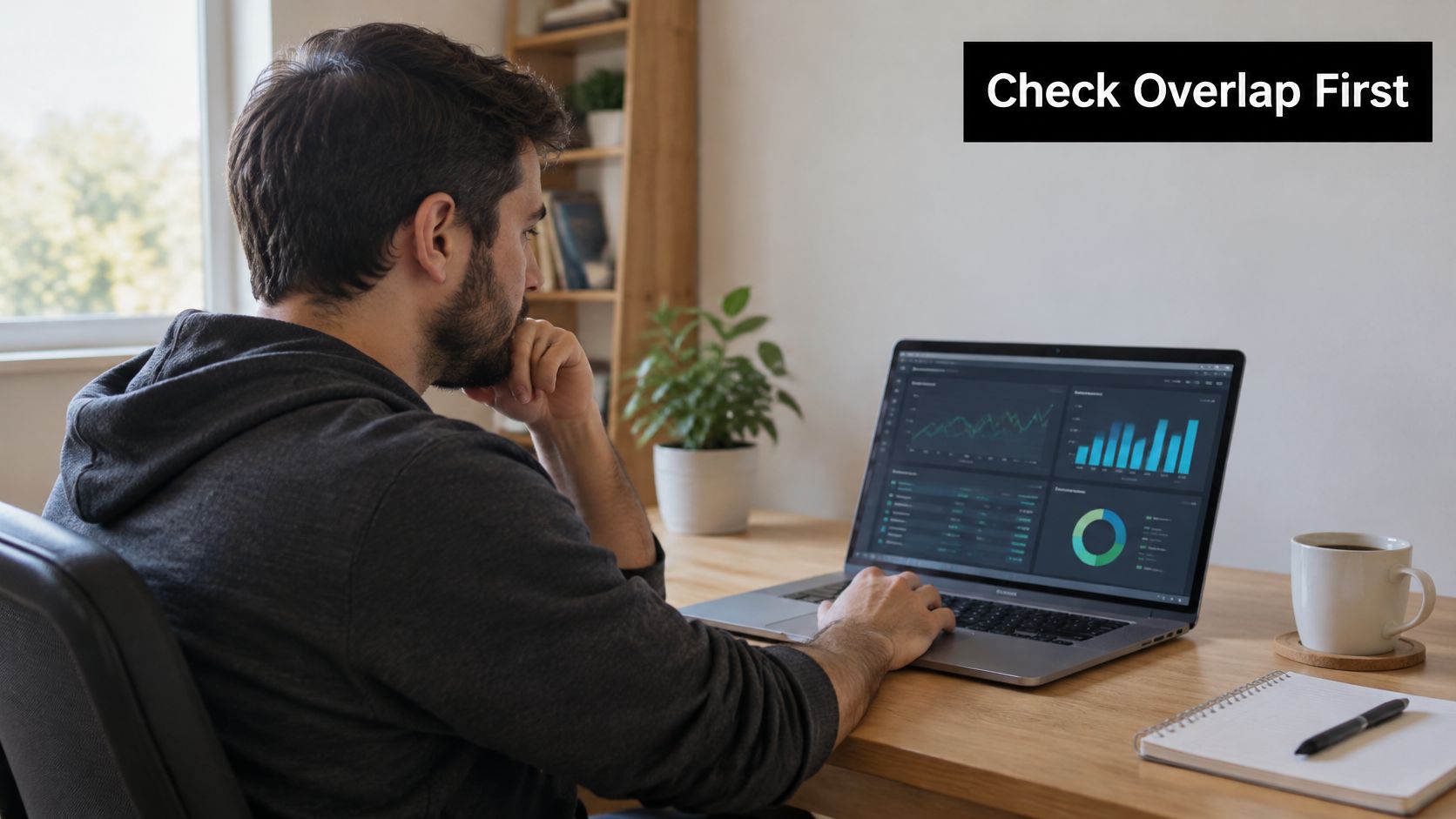 A male software developer working remotely on a laptop while reviewing data analytics and financial charts.