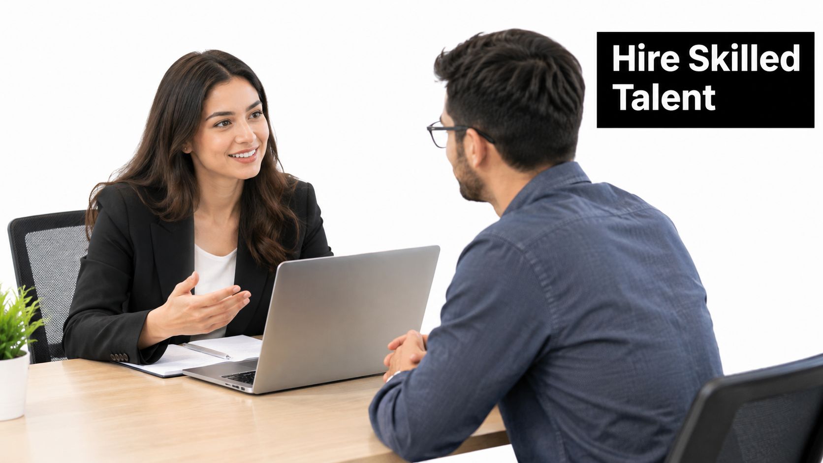 A professional woman interviewing a male candidate for a job role in a bright, modern office setting.