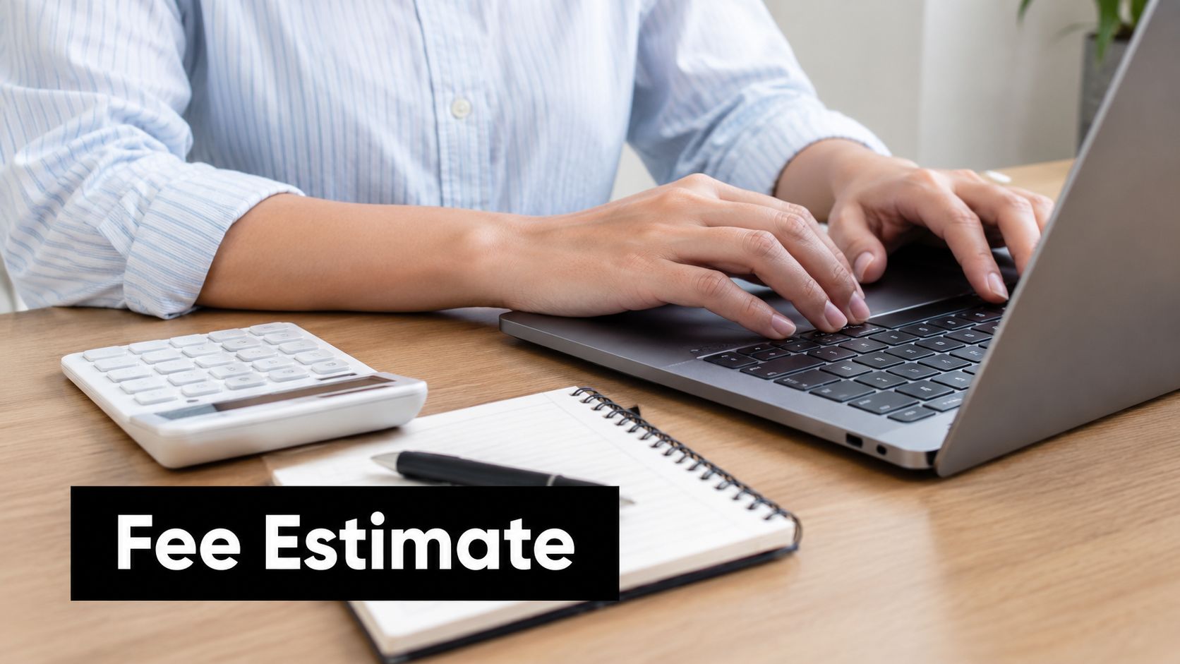 A professional working on a laptop with a calculator and notebook to prepare an employment visa fee estimate.