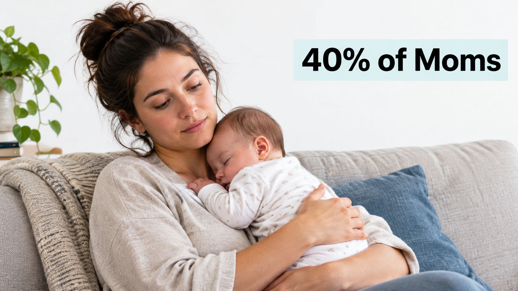 A gentle mother holding her sleeping baby while sitting on a couch in a cozy home.