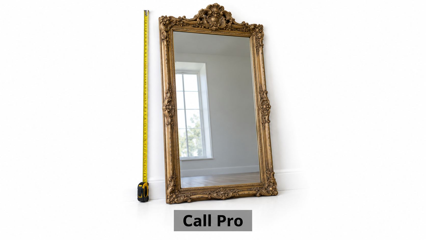 A large ornate antique gold frame floor mirror leaning against a white wall with a measuring tape.
